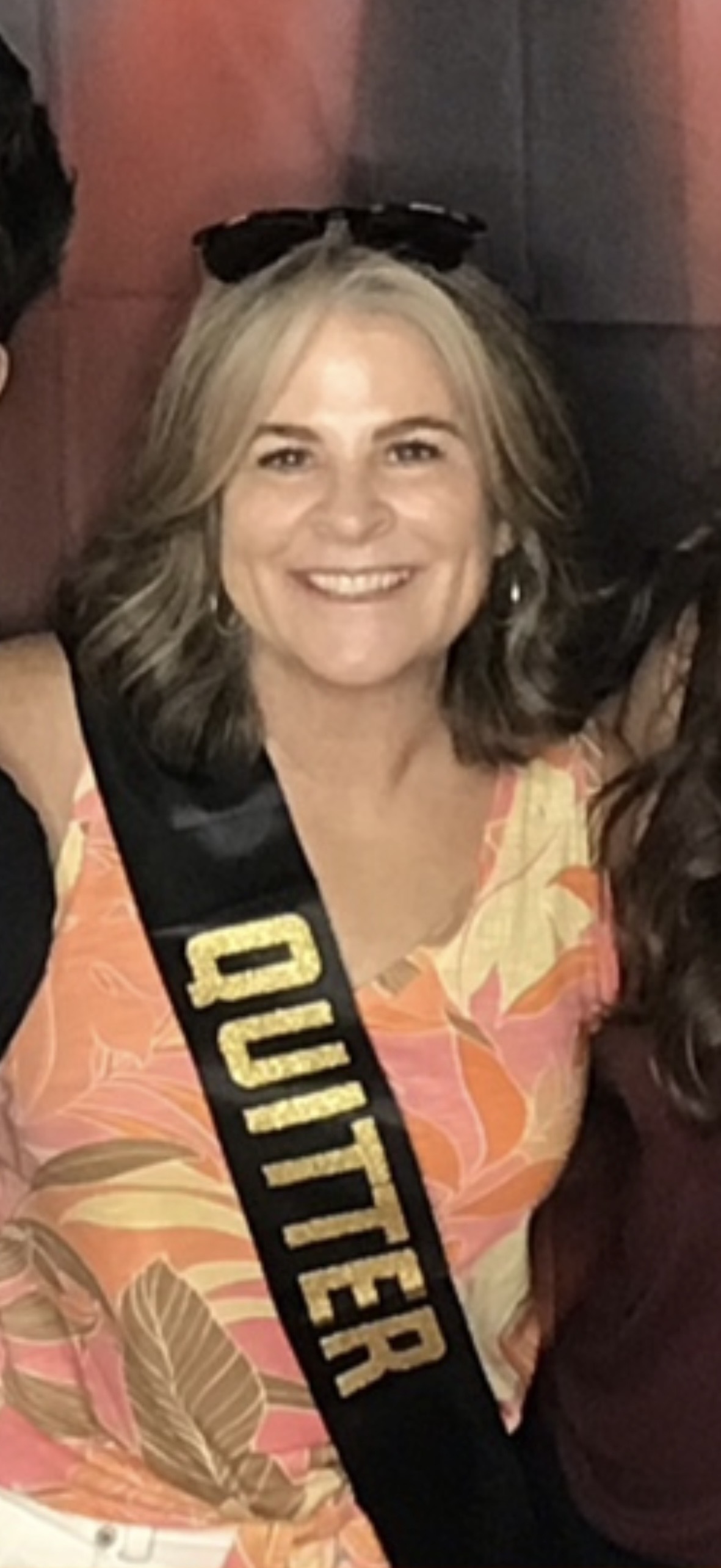 Jackie at her retirement celebration wearing a Quitter sash